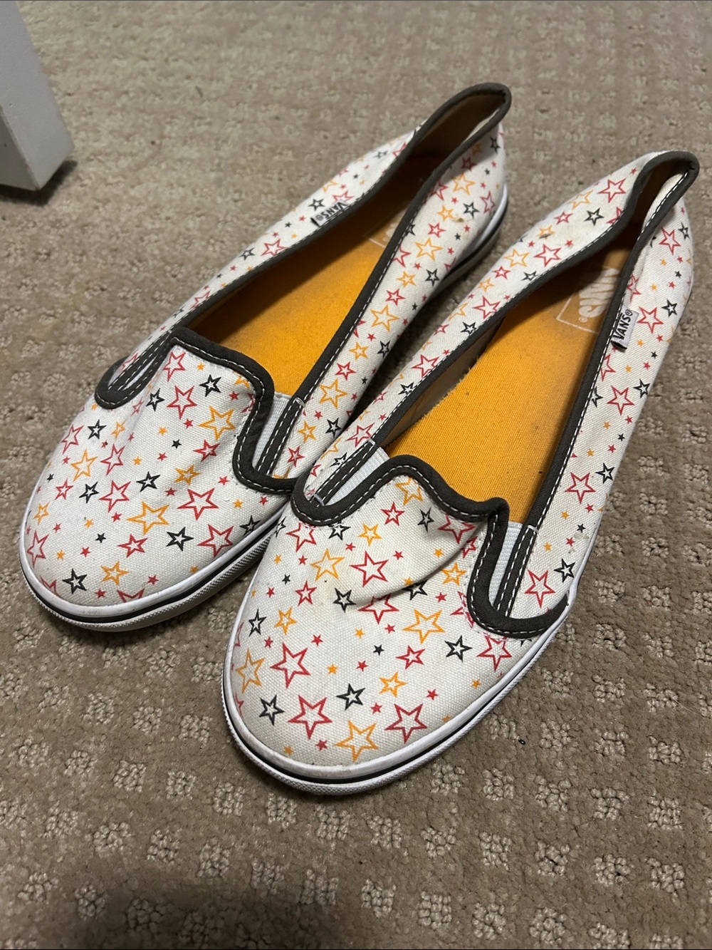 Vans White Canvas Slip-On Shoes with Red, Yellow, Black Stars